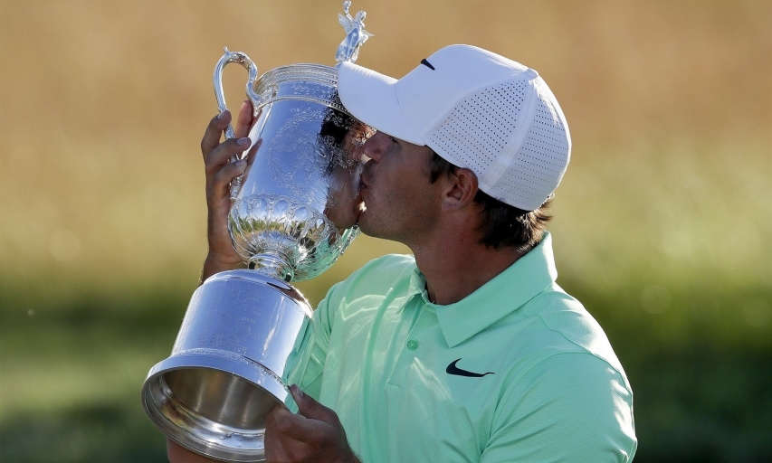 Brooks Koepka kisses the U.S. Open trophy